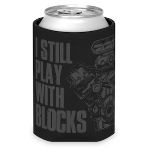 May include: Black neoprene can cooler with a gray print of an engine and the text "I still play with blocks".