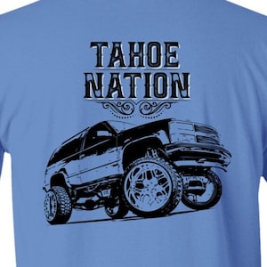 May include: A light blue t-shirt with a black graphic of a Tahoe SUV and the text "Tahoe Nation" on the back.