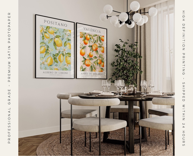 A set of two dining room or kitchen prints featuring an illustration of a lemon tree with bright yellow lemons set on a light blue background and an orange tree with sun-kissed oranges seton a light pink background.