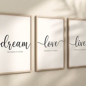 May include: Three framed prints with inspirational quotes. The first print says "dream without fear", the second print says "love without limits", and the third print says "live without regrets".
