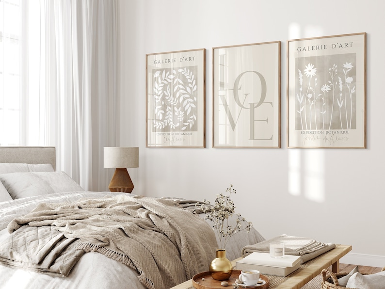 May include: Three framed prints with a beige background and white botanical illustrations. The prints are titled "Galerie d'Art" and feature the words "Love" and "Exposition Botanique".