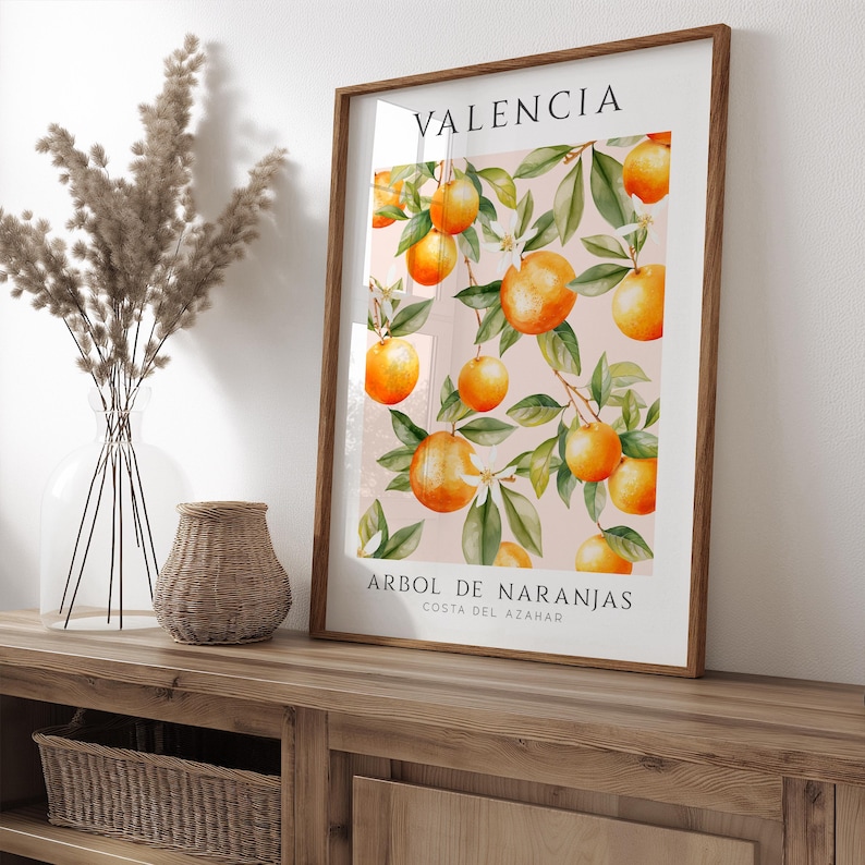 May include: A framed print with a watercolor illustration of orange trees with ripe oranges. The print has the text "VALENCIA" and "ARBOL DE NARANJAS COSTA DEL AZAHAR" in black.