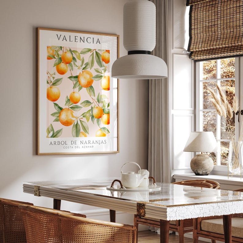 May include: A framed print with a watercolor illustration of orange trees with the text "Valencia Arbol de Naranjas Costa del Azahar" on a light pink background.