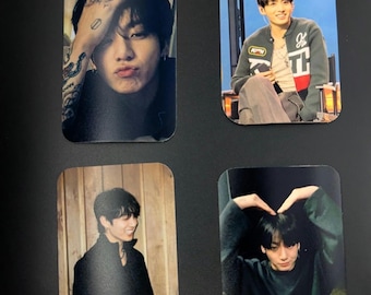 May include: Four rectangular photo cards featuring a young person with dark hair. One shows a close-up with hand tattoos, another shows a person in a green jacket, one shows a person in a black jacket against wood, and one shows a person making a heart shape.