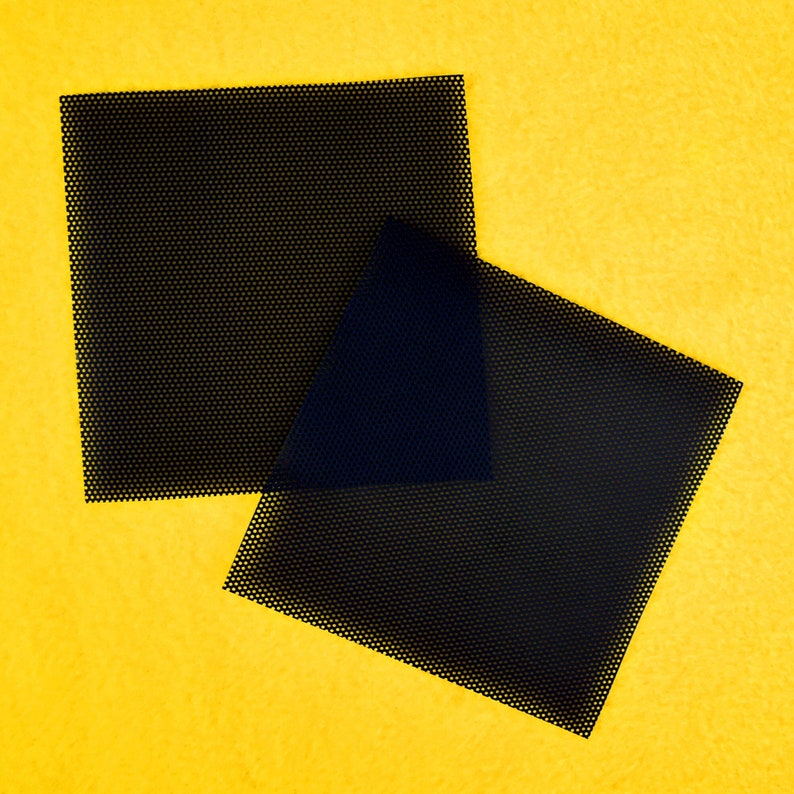 May include: Two black square-shaped mesh screens on a yellow background.