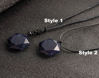 May include: Two dark blue gemstone pendants with a sparkling effect, each with a different style of black cord. One pendant is labeled "Style 1" and the other is labeled "Style 2". The gemstones have a faceted, geometric shape.