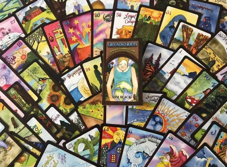 May include: A deck of Grounded Roots Intuitive Guidance Cards with a brown background and colorful illustrations. The cards feature a variety of themes, including nature, animals, and spirituality. The deck is designed to help users connect with their intuition and gain clarity on their life path. The box features the text "Grounded Roots Intuitive Guidance Cards" and "Sam Black".