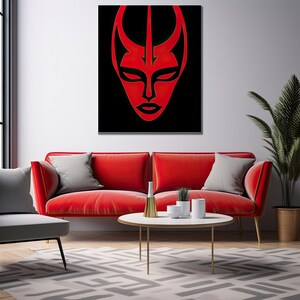May include: A red abstract face with a black background, hanging on a white wall above a red sofa and a coffee table with a vase and plants.