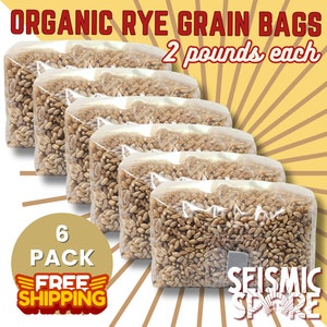 May include: Six clear plastic bags filled with organic rye grain, each bag containing 2 pounds of grain. The bags are stacked on top of each other, with the top bag partially visible. The text "ORGANIC RYE GRAIN BAGS 2 pounds each" is printed in red on a white background above the bags. The text "6 PACK FREE SHIPPING" is printed in red and yellow on a white background below the bags. The text "SEISMIC SPARE" is printed in white on a red background below the bags.