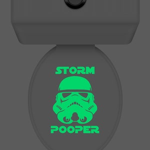 May include: A green glow-in-the-dark toilet seat lid with a Stormtrooper graphic and the text "STORM POOPER".