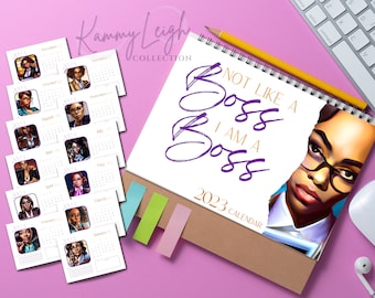 May include: A 2023 calendar with a purple and white design. The cover features a woman with glasses and the text "Not Like A Boss I Am A Boss".