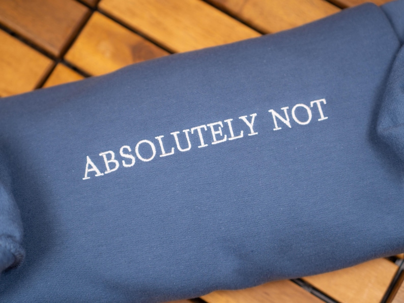 May include: A dark blue sweatshirt with the text "ABSOLUTELY NOT" embroidered in white.