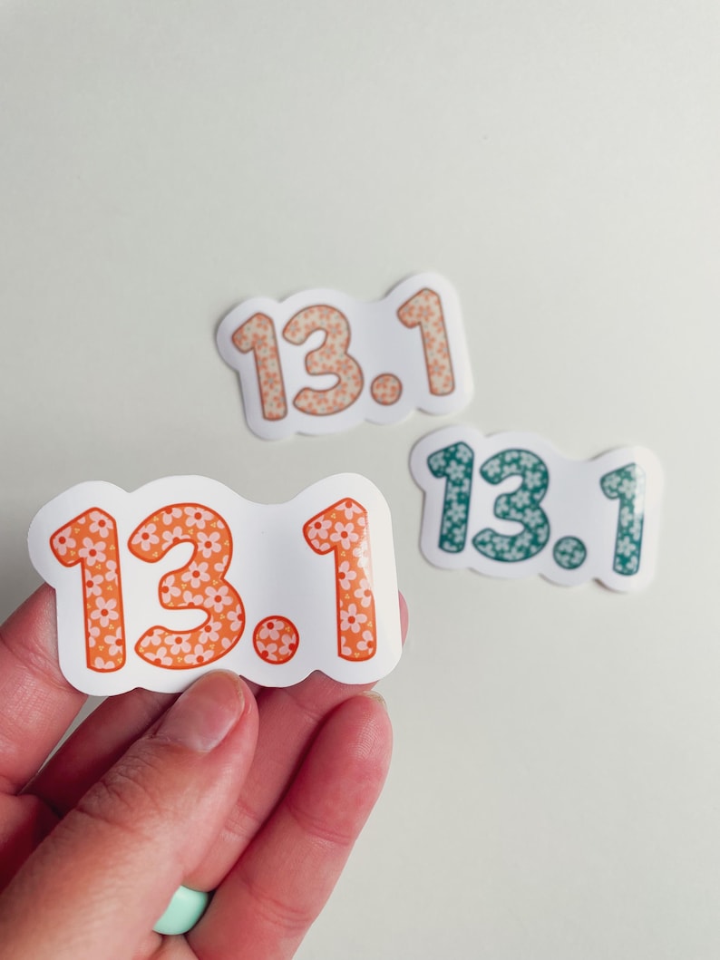 Puede incluir: Tres pegatinas con el texto "13.1" en un dise&ntilde;o floral. Las pegatinas son de color naranja, melocot&oacute;n y verde azulado. Las pegatinas est&aacute;n sobre un fondo blanco.
