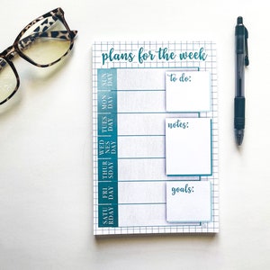 May include: A weekly planner with a teal and white color scheme. The planner has a grid layout with spaces for each day of the week, along with sections for to-do list, notes, and goals.