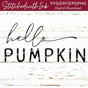 May include: Black and white text on a white wood background that reads "hello pumpkin".