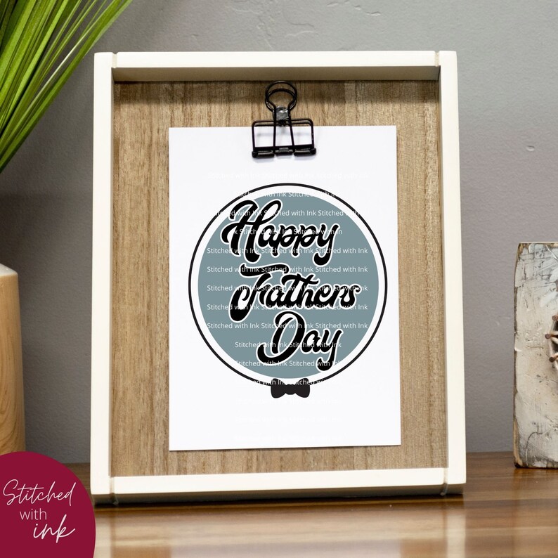 May include: A blue and white circular design with the text "Happy Fathers Day" in black script font. The design is surrounded by a black stitched border and a black bow tie.