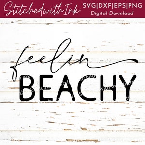 May include: Black and white text graphic design on a white wood background. The text reads "feelin beachy".