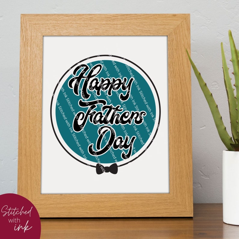 May include: A framed print with a teal circle containing the text "Happy Fathers Day" in black script. The circle is surrounded by the text "Stitched with Ink" repeated multiple times. A black bow tie is below the circle.