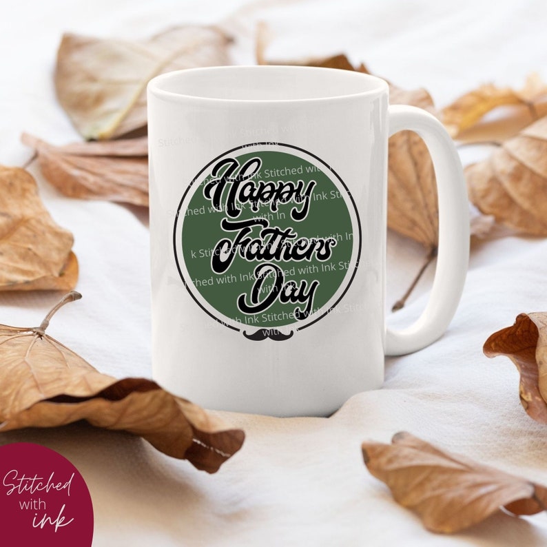 May include: White ceramic mug with a green circle design that says "Happy Fathers Day" in black script. The circle has a black stitched border and a black mustache at the bottom.
