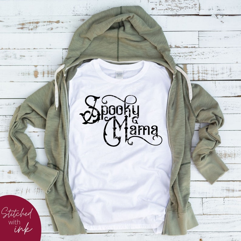 May include: White t-shirt with a black graphic that says "Spooky Mama" in a decorative font.