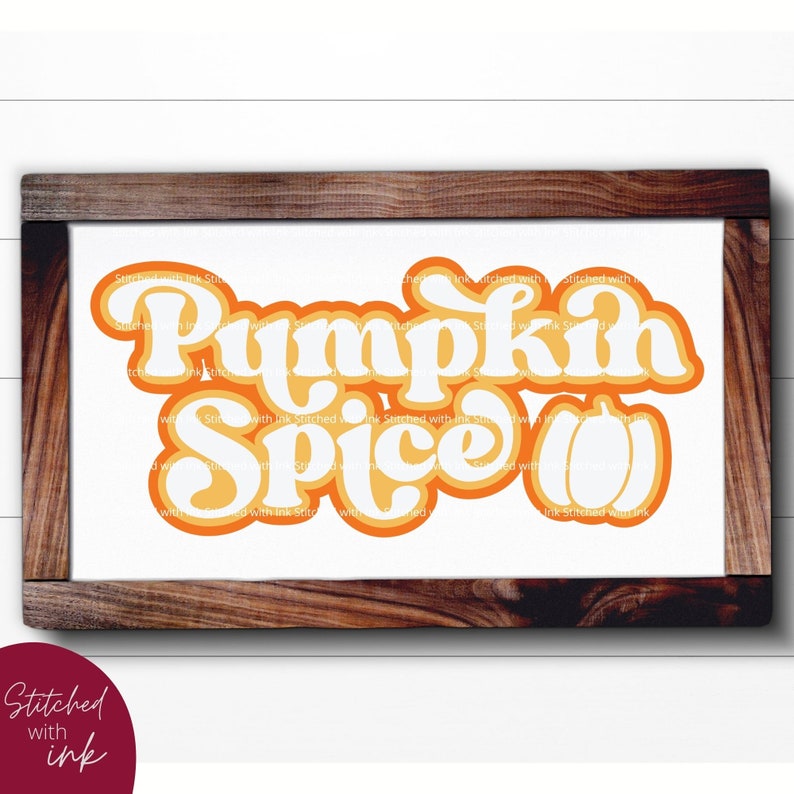 May include: A white sign with a brown wooden frame, featuring the text "Pumpkin Spice" in a retro orange and yellow font. The text is layered with a white outline and a shadow effect.