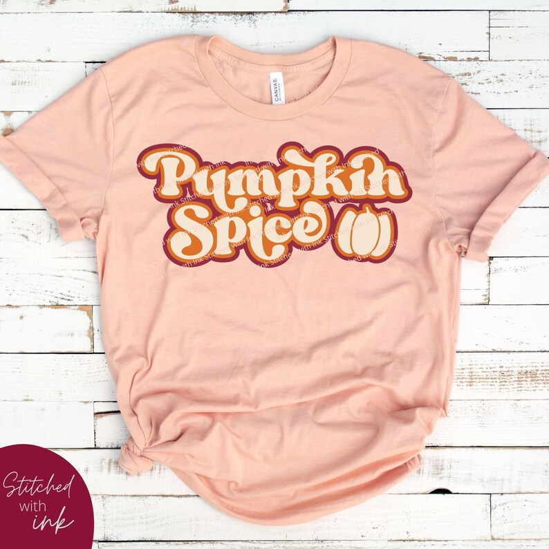 May include: A peach-coloured t-shirt with the text "Pumpkin Spice" in a retro font with a pumpkin graphic.