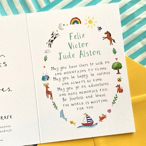 May include: A white card with a colourful illustration of animals and a rainbow. The card has a message that reads "May you have stars to wish on and mountains to climb. May you be happy, be curious and always be kind. May you go on adventures and make memories too. Be fearless and brave, the world is waiting for you." The card is personalised with the names "Felix Victor Jude Alston".