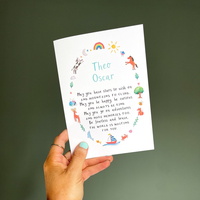 May include: A white card with a colourful illustration of animals and a rainbow. The card has the text "Theo Oscar" and a poem about wishing on stars, climbing mountains, being kind, and going on adventures.