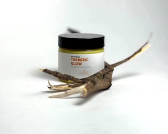 May include: A small jar of turmeric glow whipped body butter. The jar is labeled "100% Vegan Turmeric Glow Whipped Body Butter".