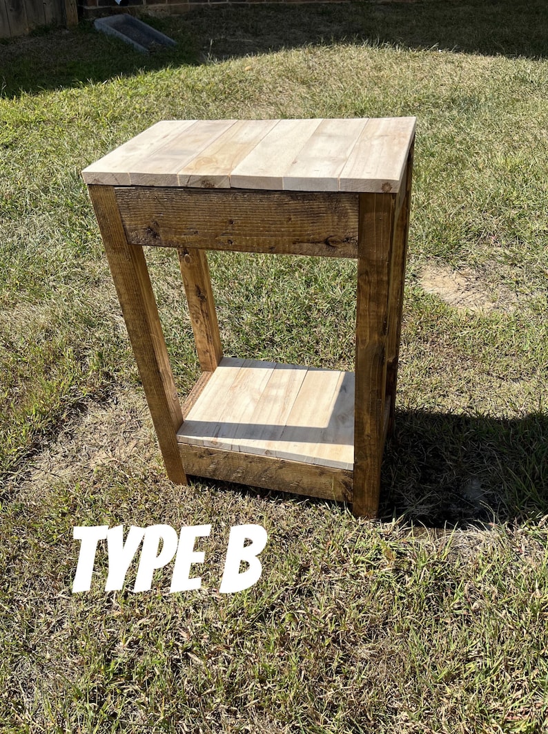 May include: A rustic wooden end table with a single drawer and a lower shelf. The table is stained in a dark brown colour and has a natural wood finish. The table is labelled "TYPE B".