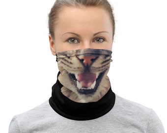 May include: A black face mask with a cat's face printed on it. The cat's mouth is open and its tongue is sticking out.