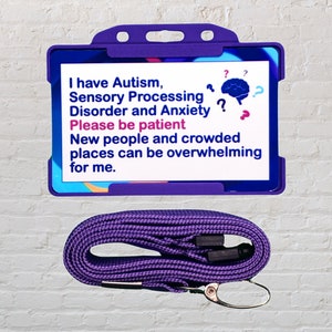 May include: Purple lanyard with a purple plastic ID card holder. The card has white text that reads: "I have Autism, Sensory Processing Disorder and Anxiety? Please be patient. New people and crowded places can be overwhelming for me." A blue brain with question marks is in the upper right corner of the card.