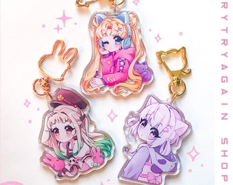 May include: Four colorful anime character keychains with gold metal rings. Each keychain features a different character with a unique design and color scheme. The keychains are perfect for adding a touch of anime style to your keys, bags, or backpacks.