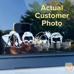 May include: A white vinyl decal of five stylized human figures, including a woman with a hat, a woman with long hair, a man with glasses, a woman with long hair, and a man with short hair. The decal is on the back window of a car. The text "Actual Customer Photo" is above the decal.