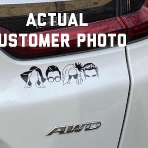 May include: A white car with a black decal of five stylized figures on the back. The decal is a silhouette of five people with different hairstyles. The text "ACTUAL CUSTOMER PHOTO" is above the decal.