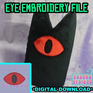 May include: Black plush toy with a large red eye and a black pupil. The toy is shaped like a pointy, triangular head. The text "EYE EMBROIDERY FILE" is at the top of the image. The text "SKUNKY DESIGNS" is at the bottom of the image. The text "*DIGITAL DOWNLOAD*" is at the bottom of the image.