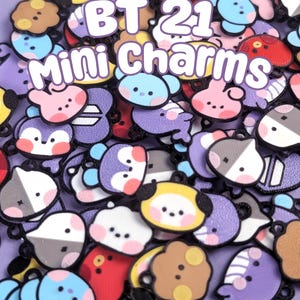 May include: A collection of small, colorful BT21 character charms featuring various shapes and designs with black outlines. The text BT21 Mini Charms is printed in white with a purple outline over the assortment of cartoon-style charms.