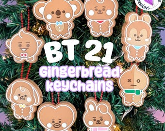 May include: A collection of eight brown gingerbread-style character keychains featuring various BT21 designs with red beaded chains. The text BT21 Gingerbread keychains is displayed in the center, with a Kimba Sprite Designs logo in the corner.