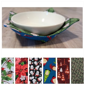 May include: A set of six different fabric designs for bowl cozies. The designs include a red poinsettia, a green holly and berry pattern, a blue gnome pattern, a black and white Santa Claus pattern, a brown and white Christmas tree pattern, and a green and black floral pattern.
