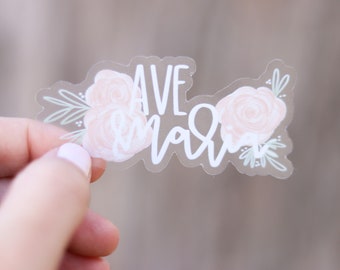 May include: Clear sticker with the text "Have faith" in white script lettering with pink floral accents.
