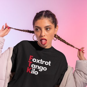 May include: Black t-shirt with white text that reads "Foxtrot Tango Kilo" in red letters.