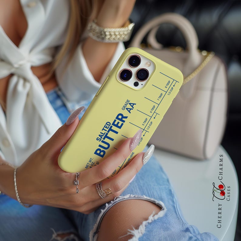 May include: A yellow iPhone case with a blue and white sticker that says "SALTED BUTTER AA" and has a measurement guide for tablespoons and cups.