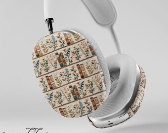 May include: White wireless headphones with a custom skin featuring a repeating pattern of books and flowers in shades of brown, orange, and green on a cream background.