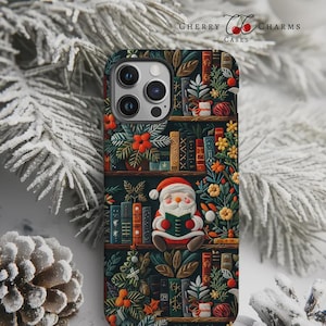 May include: A phone case featuring a festive design with a Santa Claus figure reading a book on a bookshelf. The case has a dark background with colorful books, plants, and flowers. The text "Cherry Charms Cases" is visible.