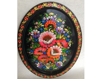 May include: A black oval tray with a gold rim and a hand-painted floral design. The flowers are red, pink, orange, yellow, blue, and purple. The tray is made in Ukraine.