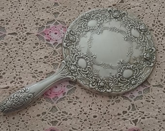 Beautiful vintage Victorian style silver plated hand held mirror with rosette design