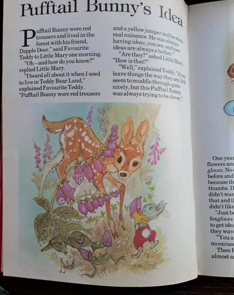 May include: A colorful illustration of a deer and a bunny wearing red pants and a yellow shirt. The bunny is holding a pair of gloves. The text "Pufftail Bunny's Idea" is at the top of the page. The text "One year flowers and gloves. No one before and because the thumbs. Didn't want that and they didn't like Just be foxgloves to get ideas they wave You are no excuse Then F almost as" is on the right side of the page.