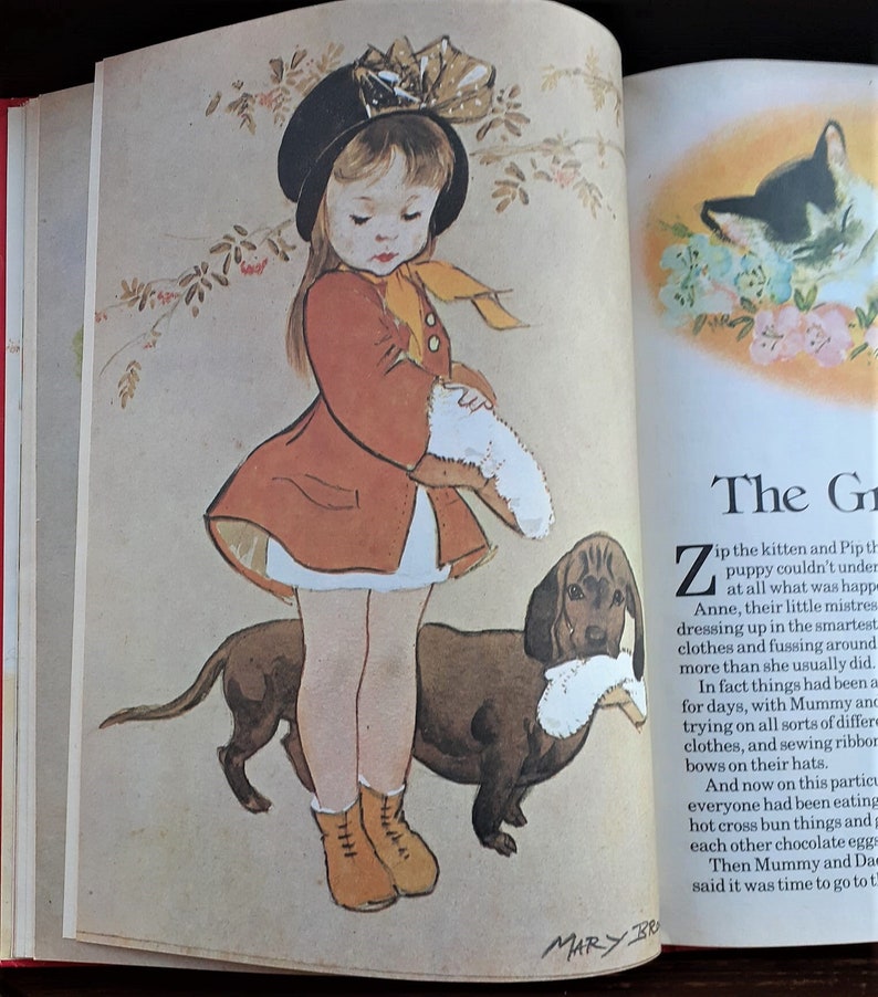 May include: A young girl in a red coat and black hat holds a white stuffed animal while walking her brown dachshund. The text "The Gr" and "Zip the kitten and Pip the puppy couldn't understand at all what was happening. Anne, their little mistress, was dressing up in the smartest clothes and fussing around more than she usually did. In fact things had been a bit trying on all sorts of different clothes, and sewing ribbons and bows on their hats." is visible on the page.