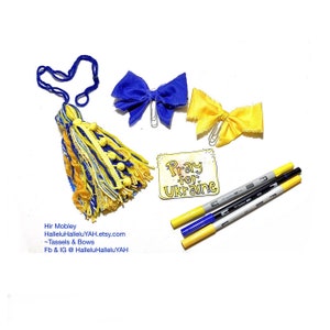 May include: A yellow and blue tassel with a blue and yellow bow, a yellow and blue bow, and three markers. The sign says "Pray for Ukraine".