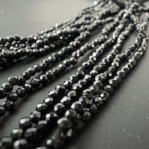 Strand of black tourmaline, schorl, faceted, 2 mm - S36